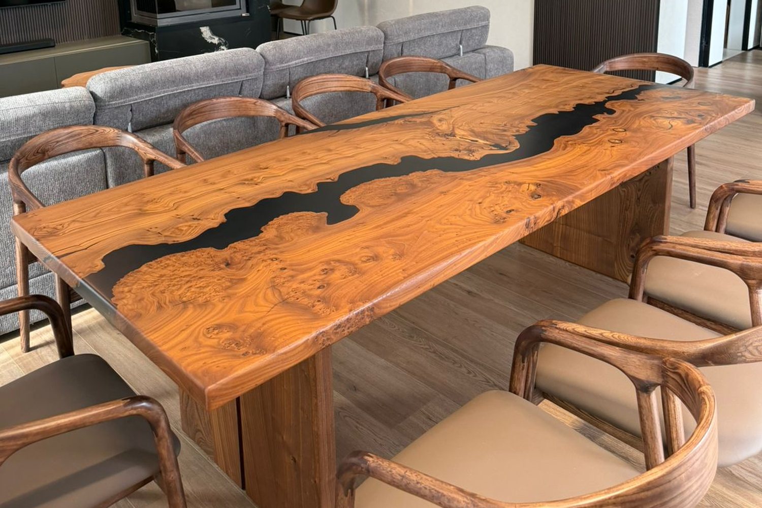 A live-edge slab table with a black epoxy river in a client's living room